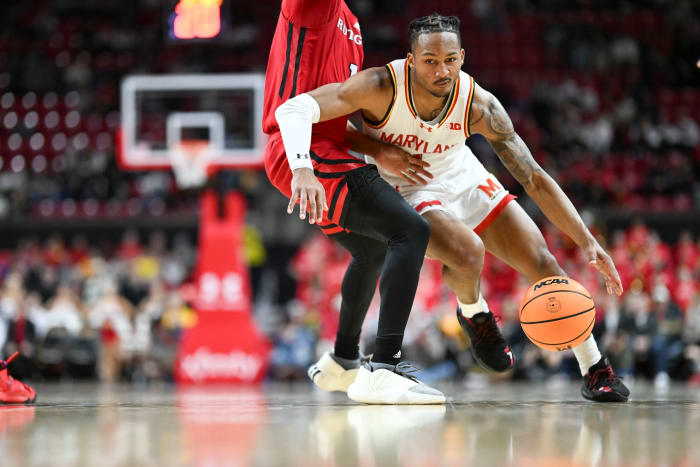 Maryland Terrapins guard Jahmir Young dribbles past Rutgers Scarlet Knights guard Jamichael Davis during the second half at Xfinity Center in College Park, Md., on Feb. 6, 2024.